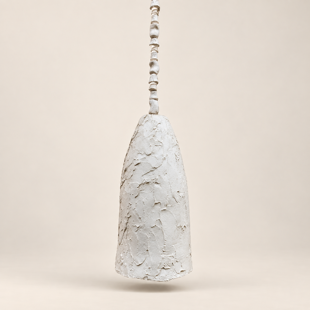 A textured, off-white ceramic pendant light with a tapered bell-shaped shade and a beaded hanging stem, shown against a solid beige background.